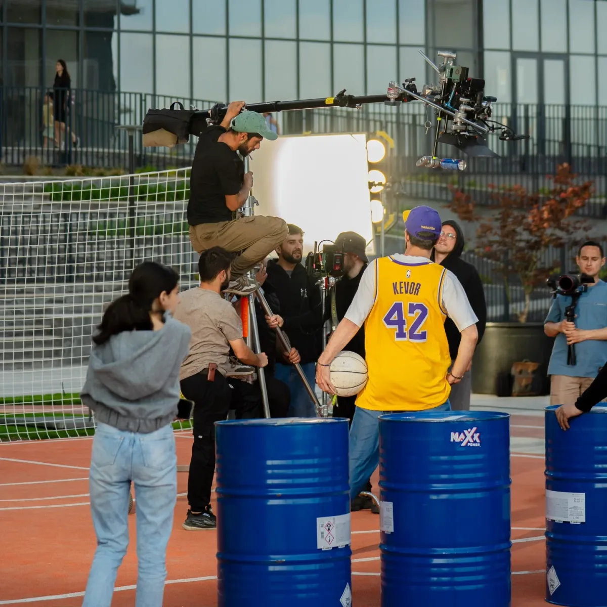 The Maxx Power set — camera crane, blue barrels and the crew